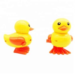 Wind-up yellow duck toy for kids with clockwork jumping action. Plastic clockwork duck toy that hops when wound, bright yellow design. Cute jumping duck toy for toddlers made of safe plastic.